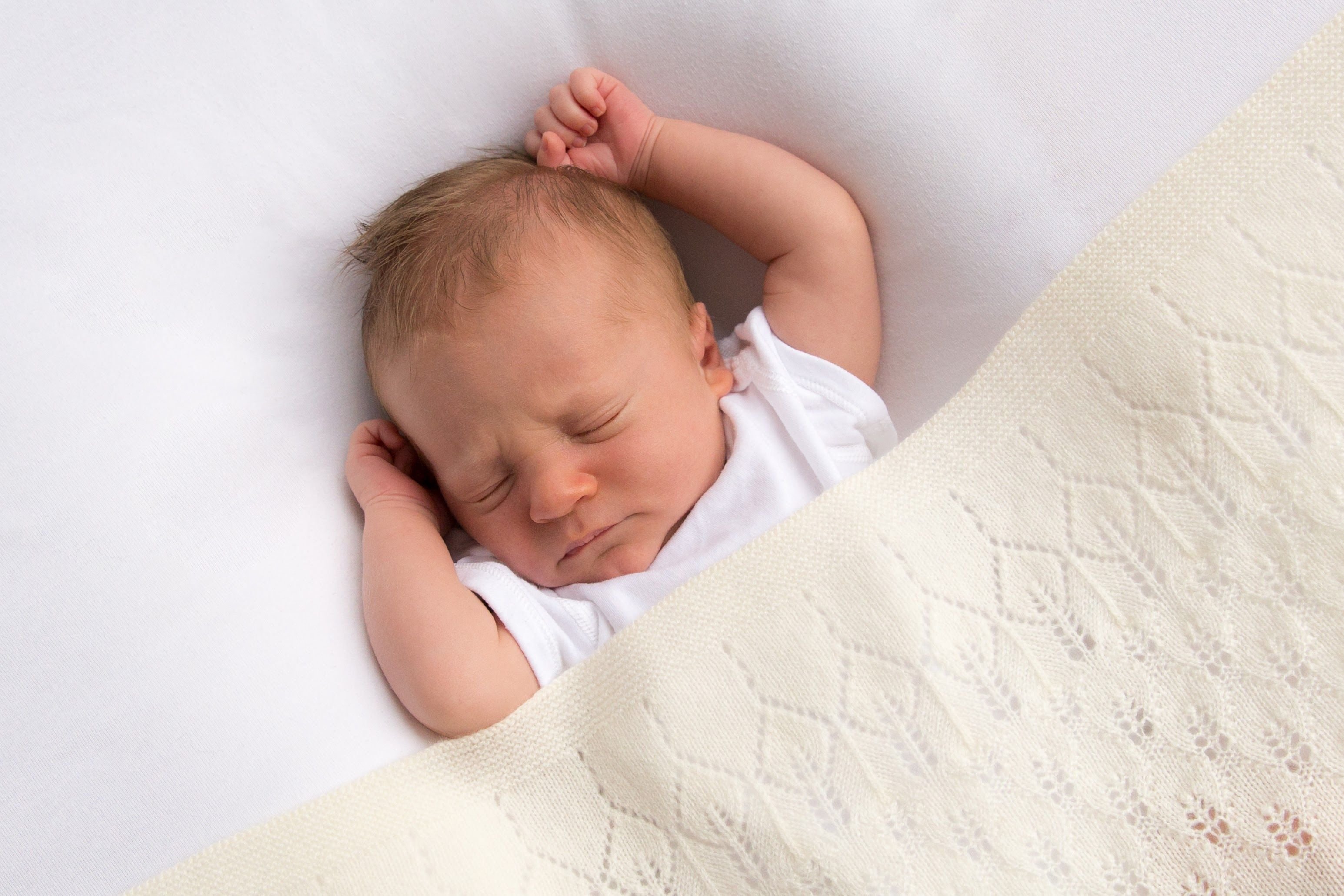 baby in white cashmere christening shawl blanket