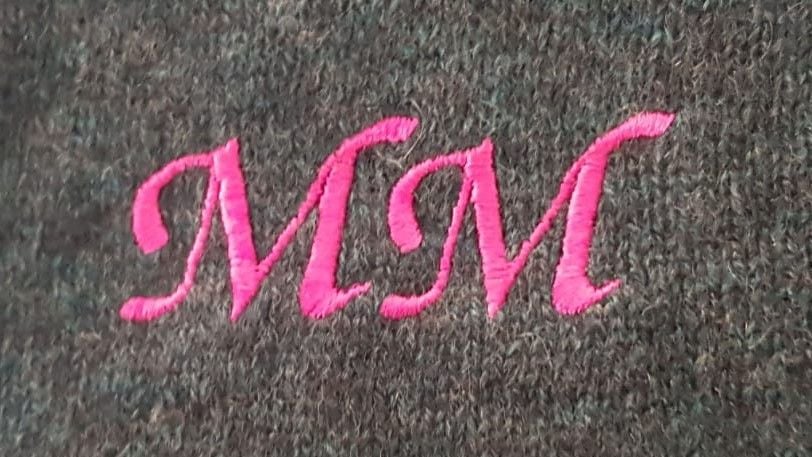 Monogrammed letters on grey cashmere shawl
